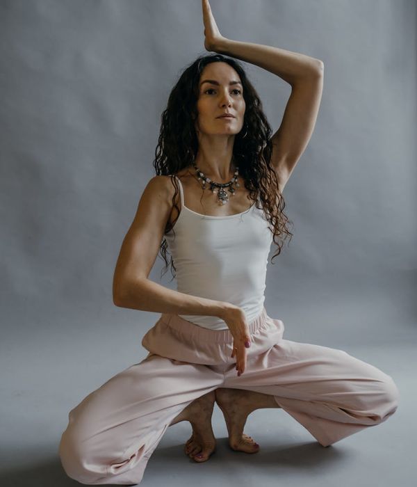 Woman in a graceful yoga pose, embodying serenity and inner strength.